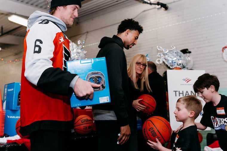 Travis Sanheim and Quentin Grimes deliver $15,000 worth of donated hockey and basketball equipment to kids at the Scanlon Recreation Center in Kensington.