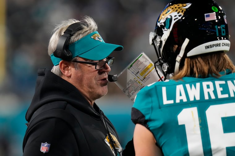 Jacksonville coach Doug Pederson confers with quarterback Trevor Lawrence during the Jaguars' comeback victory on Saturday night.