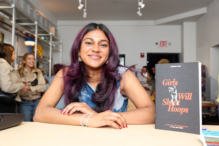 Lydia Hope Victor poses for a portrait with her zine, “Girls Will Shoot Hoops” at Another Corner Bookstore on Friday, May 8, 2026, in Philadelphia.