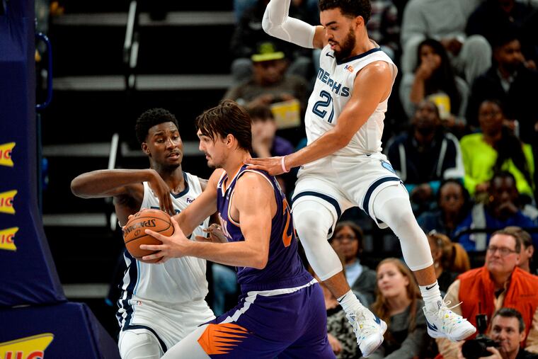 Dario Saric (middle) is averaging 9.5 points, 6.5 rebounds and 2.3 assists through six games, all starts, for the Suns.