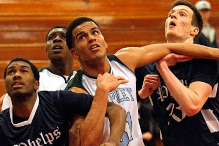 Isaiah Baker fights for rebounding position between Phelps'
Bouna Ndiaye and Mike Bedulskis (Ron Cortes / Staff Photographer)