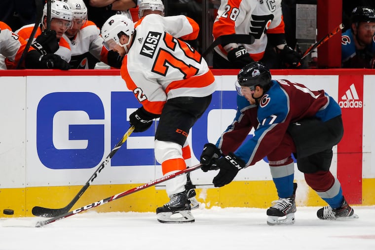 Flyers left winger David Kase, collects the puck along the boards as Colorado's Tyson Jost defends in the first period. Kase made his NHL debut in the game Wednesday.