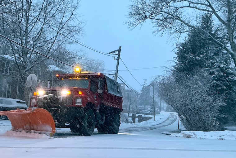 A plow starts removing snow from a residential street during the beginning of an intense winter storm, Sunday, Feb. 22, 2026, in Fort Lee, N.J. (AP Photo/Pablo Salinas)