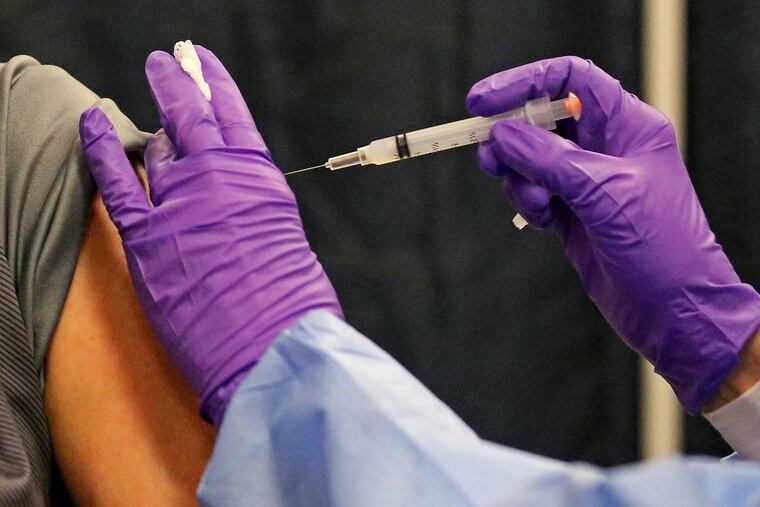 A man gets a COVID-19 vaccine at a mass vaccination site in Massachusetts earlier this year.