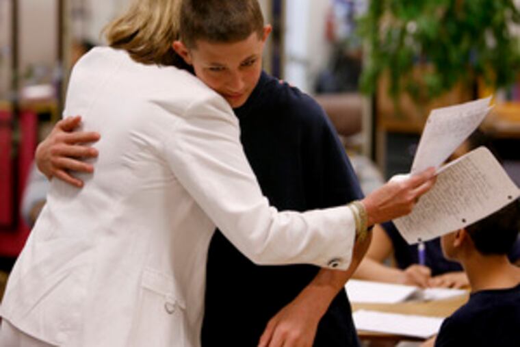 Barbra Burke, the Philadelphia School District's teacher of the year, has a hug for Patrick Burger after he handed in two book reports. Her students have talked of being transformed in their studies.