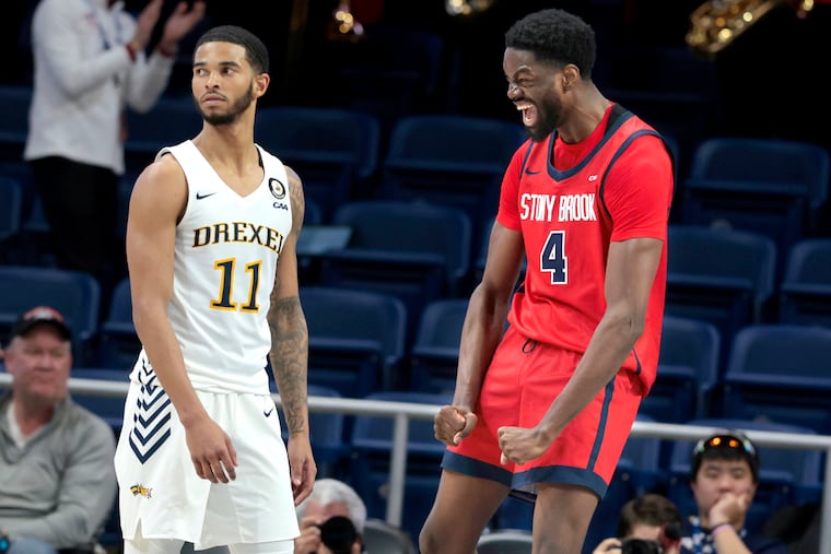 Chris Maidoh, right, of Stony Brook celebrates in front of Justin Moore after a dunk against them during the overtimes of their CAA tournament quarterfinal game on March 10, 2024.