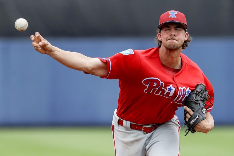 Phillies pitcher Aaron Nola throws a first-inning warmup pitch before facing Tampa Bay.