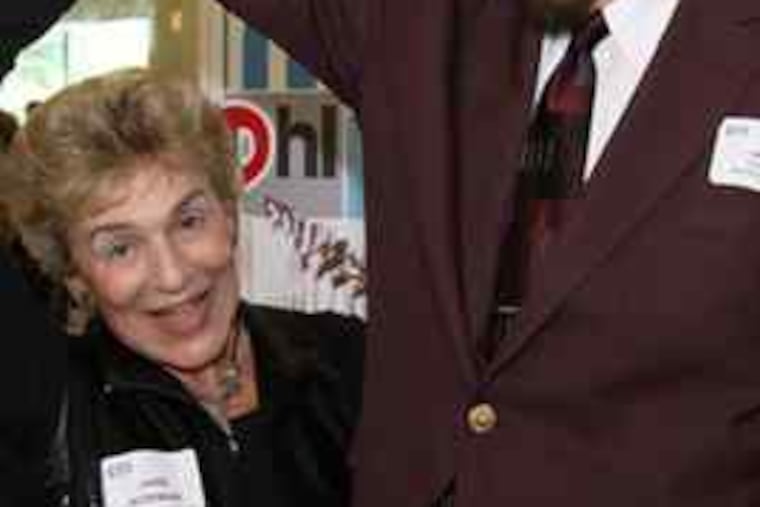 TV's Pixanne, Jane Norman, pops up next to - and under - 6-foot-5 Bill "Wee Willie" Webber. Hosts of beloved children's shows in the 1960s and '70s, both appeared at a Broadcast Pioneers of Philadelphia luncheon. (File photo)