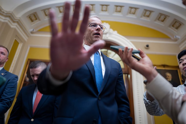 Senate Majority Leader John Thune (R., S.D.) gestures as he speaks to reporters outside the chamber Thursday.