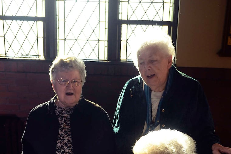 Sister Ruth Sattler plays the piano as Sister Fran (left) and Sister Donna Marie Beck sing to commemorate the 100th anniversary of the writing of "In a Manger Lowly,"