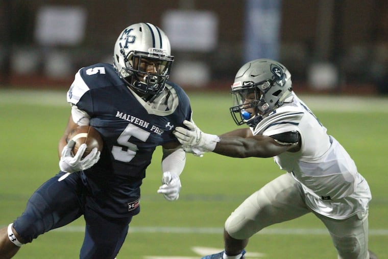 Quincy Watson (left) of Malvern Prep breaks away from the grasp of Jaylen DeCoteau of St. Augustine Prep in the 3rd quarter of their season opener at Villanova University on Sept. 1, 2017.