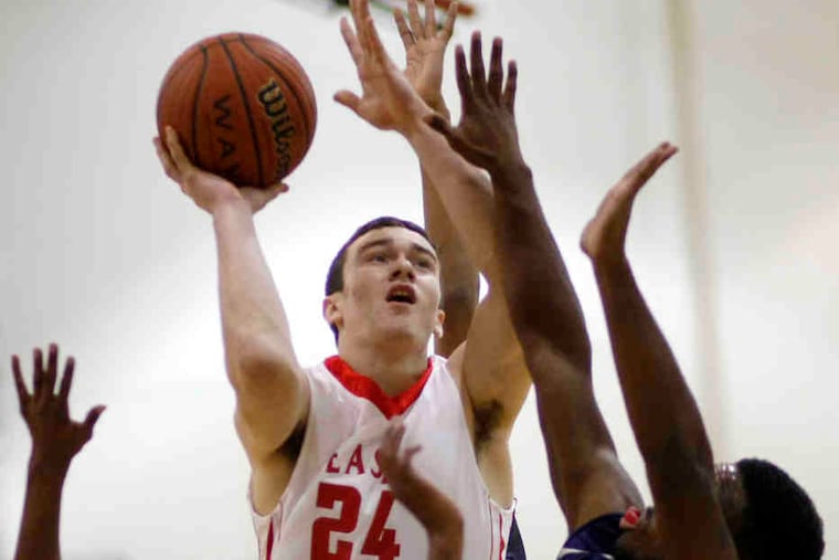 Cherry Hill East's Chris Santo shoots over Timber Creek defenders Mikal Demby (left) and D.J. Dunham.