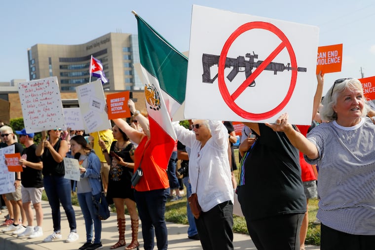 FILE - In this Aug. 7, 2019, file photo, demonstrators gather to protest after a mass shooting that occurred in Dayton, Ohio. (AP Photo/John Minchillo, File)