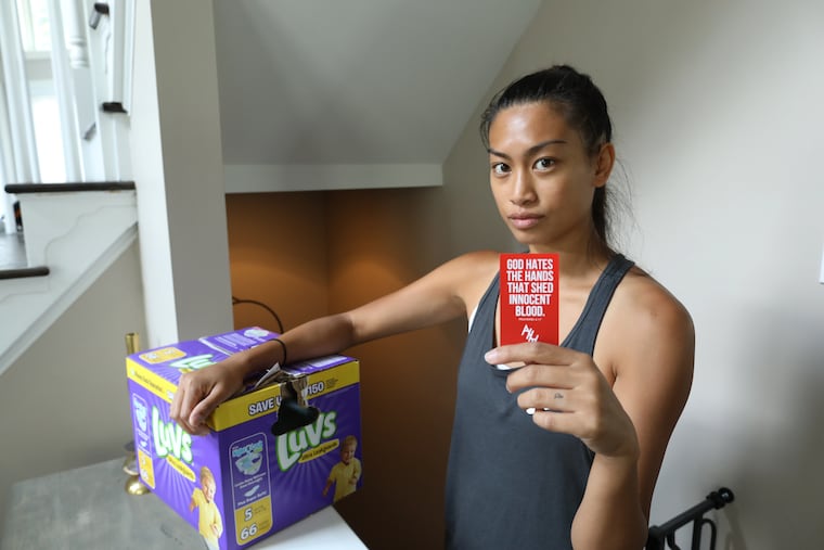 Annie Weiss, 31, of West Conshohocken, bought a box of diapers from Wegmans in King of Prussia, Pa., and found a graphic anti-abortion card inside. Wegmans told The Inquirer it found about 10 such cards tucked into various products and at least one other shopper had contacted them.