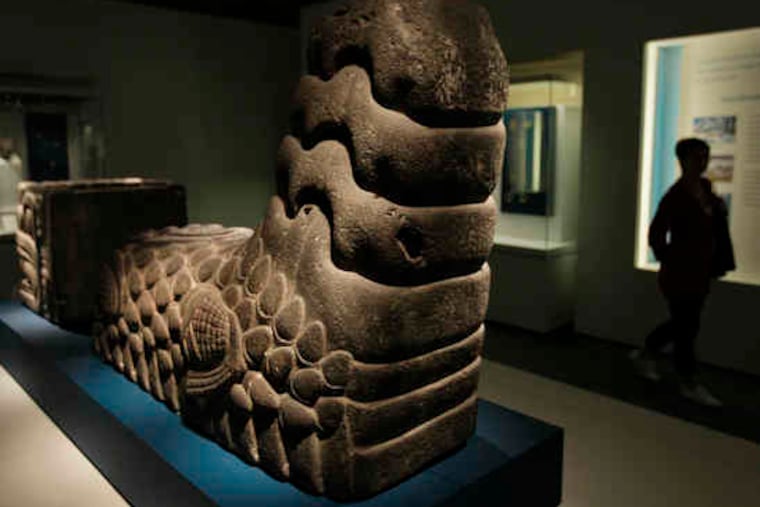 A basalt fragment, in the form of a serpent's tail, originally was part of a much larger sculpture.