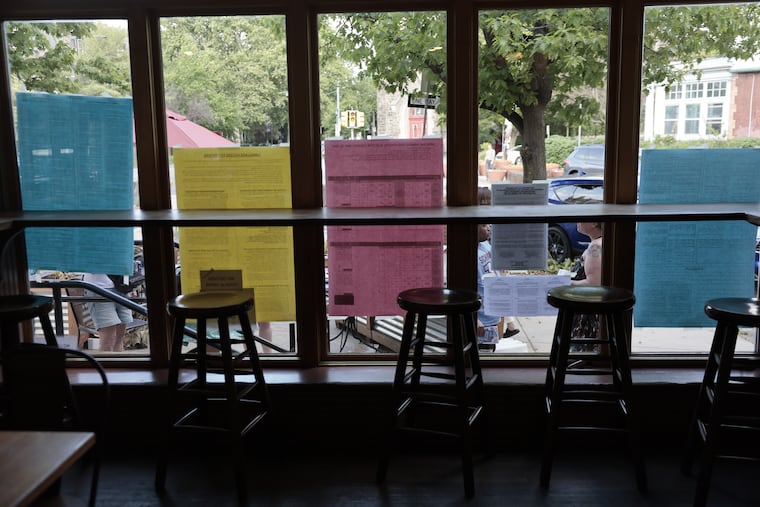 Signs in the winding at a polling location at the Gold Standard Cafe on Tuesday.