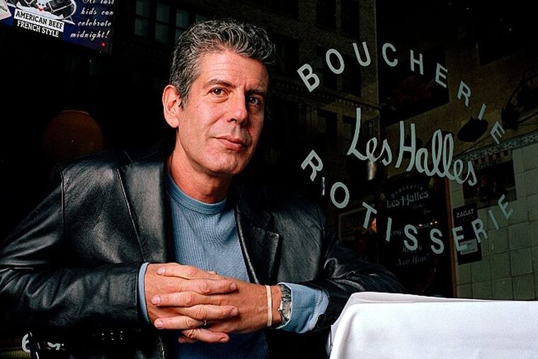 Anthony Bourdain, the owner and chef of Les Halles restaurant, sitting at one of its tables in New York in 2001.