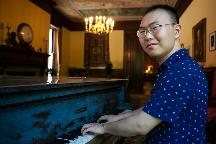 Pianist Tianxu An poses for a portrait inside the Bok Room at the Curtis Institute of Music in the Rittenhouse neighborhood of Philadelphia on Wednesday, July 17, 2019. An will perform later this week at the Mann Center with the Philadelphia Orchestra.