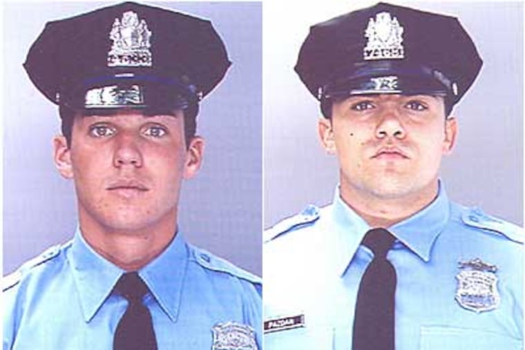 Philadelphia Police Officers Ryan Sullivan, left, and Michael Pazdan, right, and Ryan Clement, not pictured, spotted a burning house and rescued two young girls.