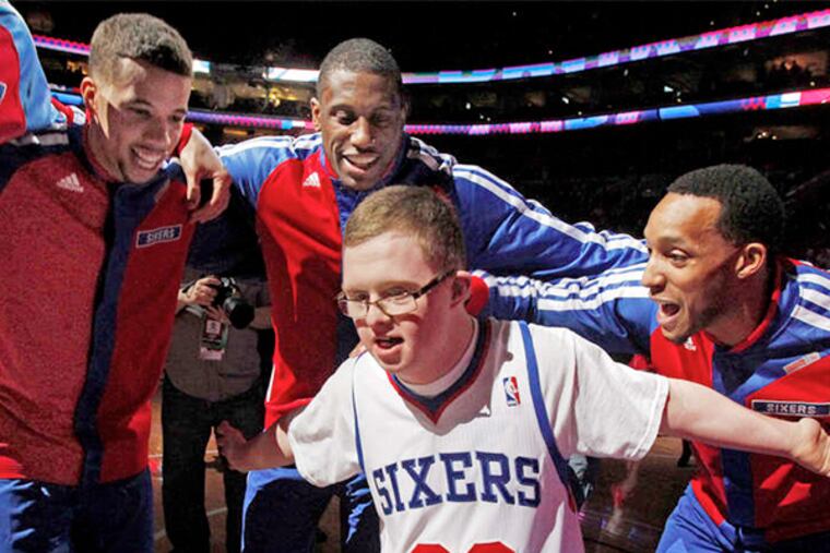Kevin Grow joining 76ers players for a pregame chant before a Feb. 18 game with Cleveland at the Wells Fargo Center. The team signed Grow to a two-day contract and he had an honorary roster spot for the game.