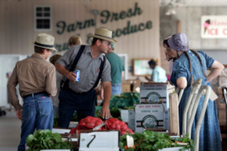 Mennonite family peruses produce. When a large buyer recently demanded tainted-food insurance, Dayton farmers balked.