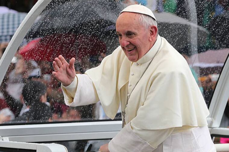 Pope Francis waves to people from his popemobile in Rio de Janeiro, Brazil, Saturday, July 27, 2013. (AP Photo/Andre Penner)