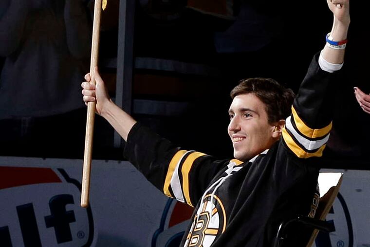 Marathon bombing victim Jeff Bauman reacts as he was honored Saturday as the flag-bearer before Game 2 of a first-round NHL hockey playoff series between the Boston Bruins and the Toronto Maple Leafs.