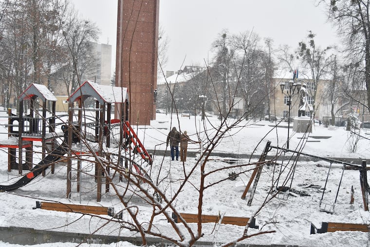 Ukrainian police officers work at the site of a Russian drone strike on a playground in Lviv, western Ukraine.
