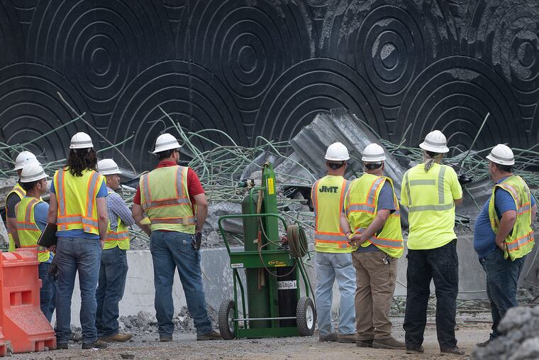 Workers on Wednesday at the site of I-95 bridge collapse over Cottman Avenue in Philadelphia after tanker fire on Sunday.