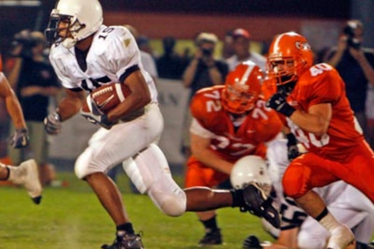Andre Hutchinson (left) runs against Cherokee. (Bonnie Weller/Inquirer)