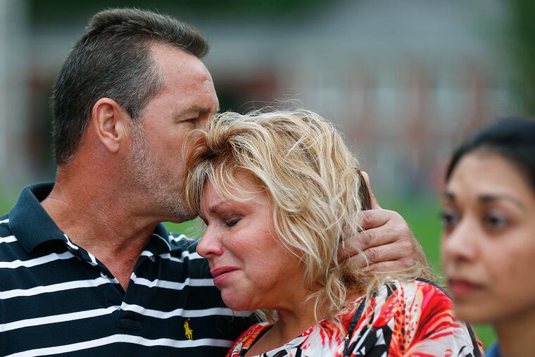 Plaintiffs Markela and Chris Sourovelis embrace as the stand beside attorney Darpana Sheth during a news conference in 2014 on Independence Mall to discuss a lawsuit alleging that Philadelphia had been seizing and selling millions in property from city residents, including those not charged with crimes.