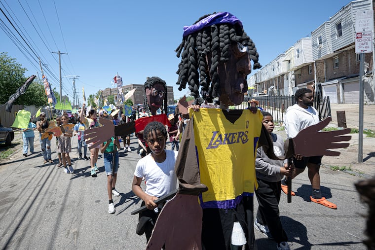 Students at Blankenburg Elementary School participate in their annual parade Wednesday, celebrating students' identities and causes they care about through giant puppets, original chants, drumming, and other artwork. This puppet, created through a program with Spiral Q, is Timothy, a teenager in long braids wearing a Lakers jersey.