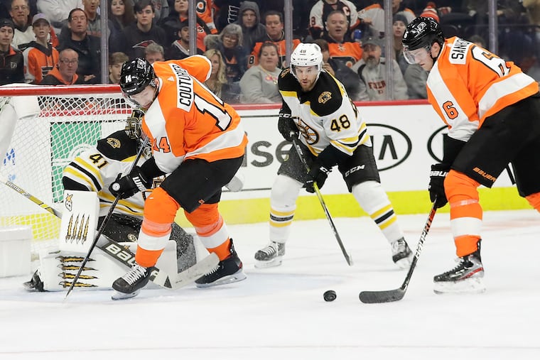 Flyers defenseman Travis Sanheim (6) whips a shot past Boston's Jaroslav Halak as Sean Couturier (14) screens the goalie. The Flyers won the Jan. 13 game in a shootout, 6-5.