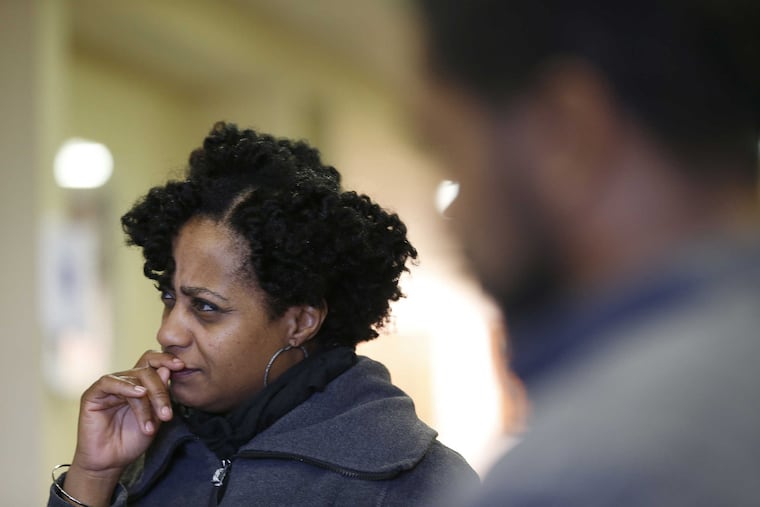 Sedrick Huckaby, at right, is pictured with singer Tanya Nolan Evans, left, as he works on a portrait at the hospital in Abington, Pa. on March 20, 2017.