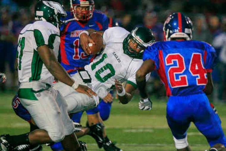 Winslow Township QB Bill Belton (10) is brought down against Washington Township. He was recruited as receiver/back.
