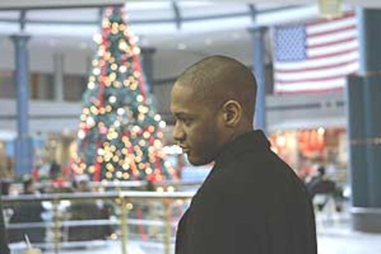 James Johnson walking back to work from the food court at Liberty Place on Thursday. He took off Wednesday to go shopping but will be back at work until the next holiday rolls around.