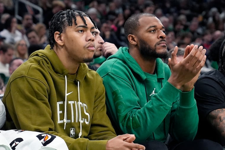 Boston Celtics' Xavier Tillman, right, and Jaden Springer sit on the bench during the first half of an NBA basketball game against the Washington Wizards, Friday, Feb. 9, 2024, in Boston. (AP Photo/Michael Dwyer)