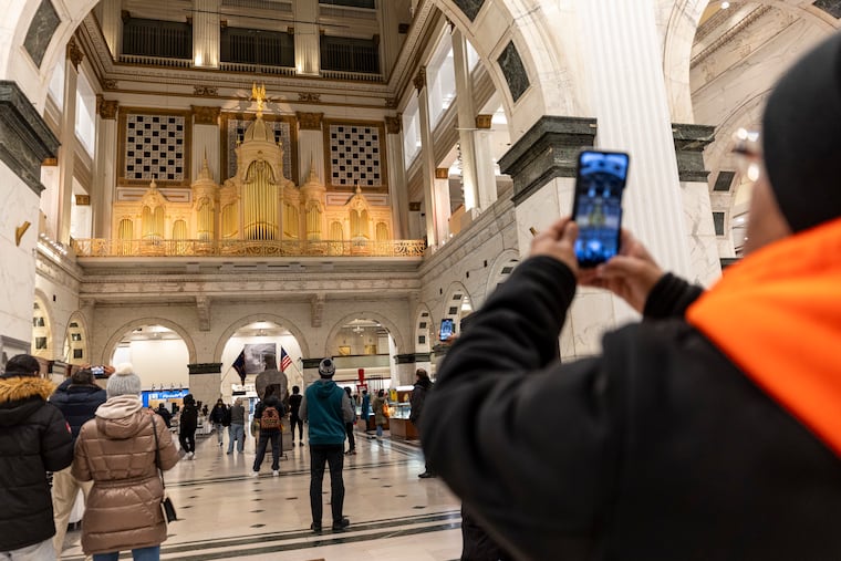 People gather inside Macy's Center City to listen to the Wanamaker Organ on Friday, Jan. 10, 2025, just before the public announcement that Macy's will be closing the store in March.