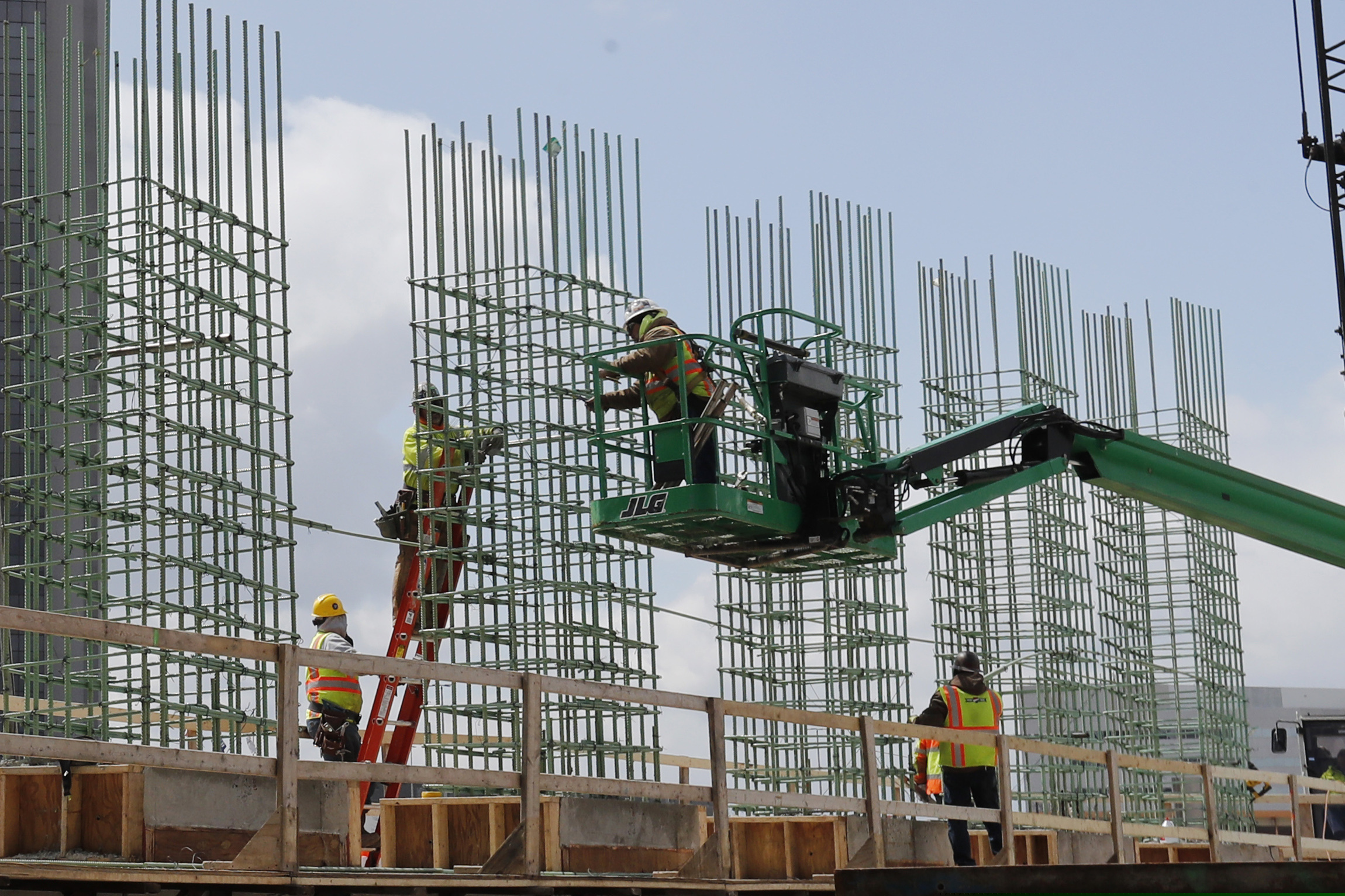 Work continues on a bridge on the Interstate Highway 75 project in Troy, Mich. Looking beyond the $1.9 trillion COVID relief bill, President Joe Biden and lawmakers are laying the groundwork for another of his top legislative priorities — a long-sought boost to the nation's roads, bridges and other infrastructure that could meet GOP resistance to a hefty price tag.