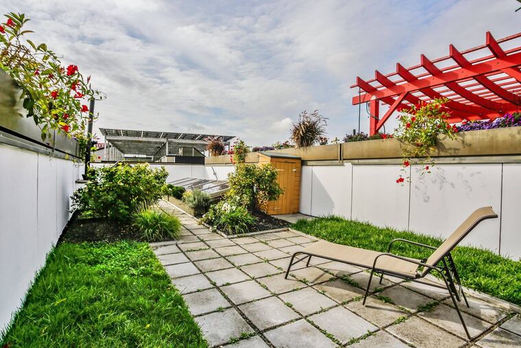 The hardscaped green roof deck has a direct natural gas line for the grill, a water line for a hose, electric outlets, and an Ethernet port.