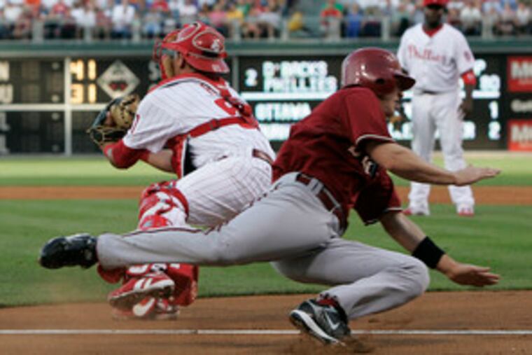 Arizona's Stephen Drew dives for the plate as Phillies catcher Carlos Ruiz awaits the throw in the second inning of last night's game at Citizens Bank Park.