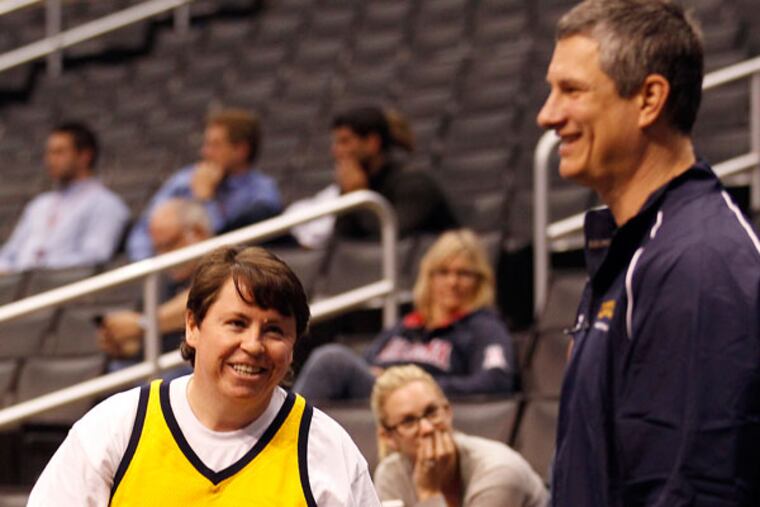 La Salle Head Coach John Giannini meets with filmmaker and La Salle graduate Kevin Williams (left) of Trenton, N.J. before practice at the Staples Center in Los Angeles, Calif. on Wednesday, March 27, 2013. (Yong Kim/Staff Photographer)