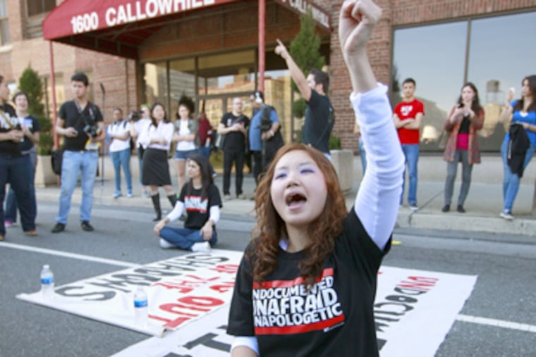 Jessica Hyejin Lee demonstrates at the ICE building in Philadelphia. She and Tania Chairez (seated in background), both illegal immigrants, were arrested. (David Swanson / Staff Photographer)