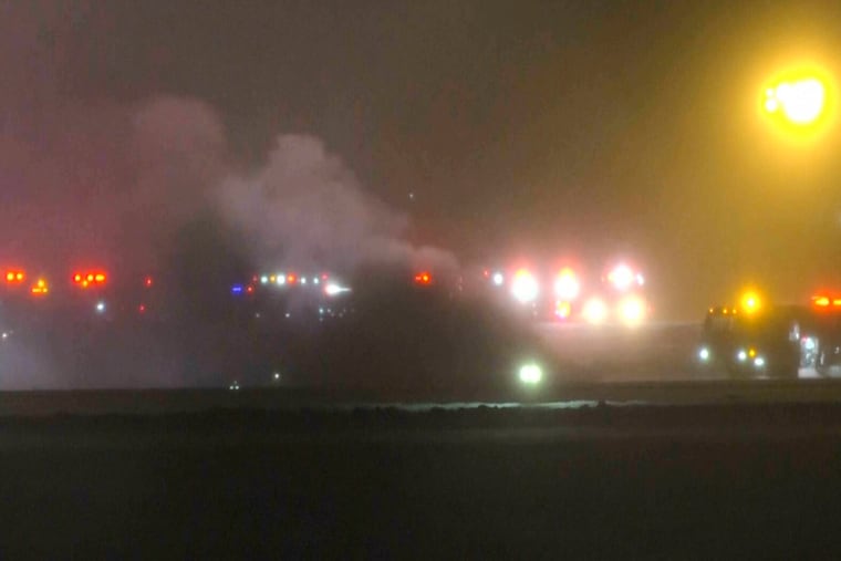 In this image taken from video provided by WABI television, emergency responders work on the scene of the Bombardier Challenger 600 crash at the Bangor Airport in Maine, Sunday, Jan. 25, 2026.
