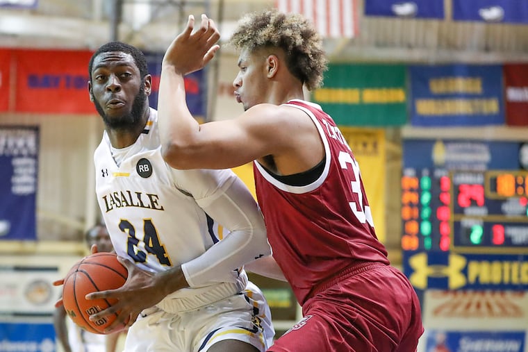 La Salle forward Jared Kimbrough (24) posts up against UMass defender Tre Mitchell in the second half.