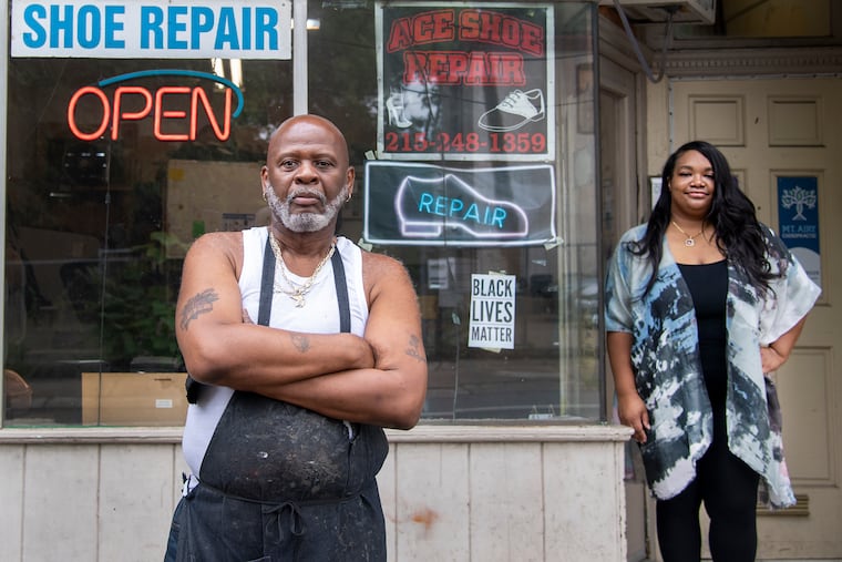 Shani Newton and Willie Alston are photographed outside Ace Shoe Repair in Mount Airy. Newton, owner of Dolly's Boutique, recently posted a plea to customers to support Ace Shoe Repair, a business up the street, and customers responded.