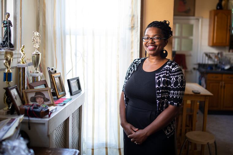 Temwa Wright, 38, of West Philadelphia, poses for a portrait inside her home on Tuesday, July 21, 2020. Wright has three children and two of her kids, Samuel Wright, 11, who will enter the 6th grade and Emmaneul Wright, 13, who will enter the 8th grade. “I’m excited, I think it’s a good plan and they put a lot into the plan,” Wright said. “We have to provide controlled learning environments. You can’t control a home environment because different families have different resources to support their children. If my kid isn’t disciplined enough to get on the computer they’re not going to learn.”