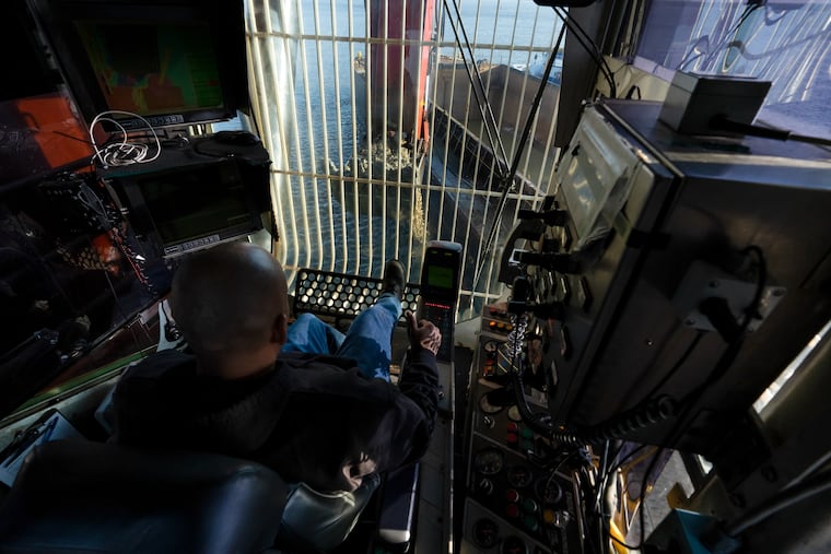 Steve Castillo operates the 13-cubic-yard excavator used to break up and dredge rock from the Delaware River. JESSICA GRIFFIN / Staff Photographer