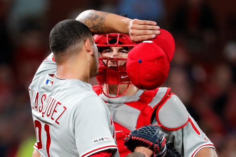 J.T. Realmuto chatting with pitcher Vince Velasquez during Monday night's loss in St. Louis.