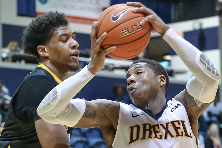 Drexel's Kazembe Abif looks to pass around Towson's Walter Foster on Thursday, Jan. 28, 2016.